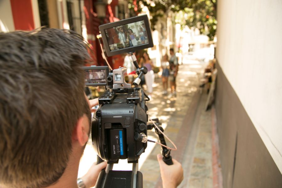 person filming while holding video camera